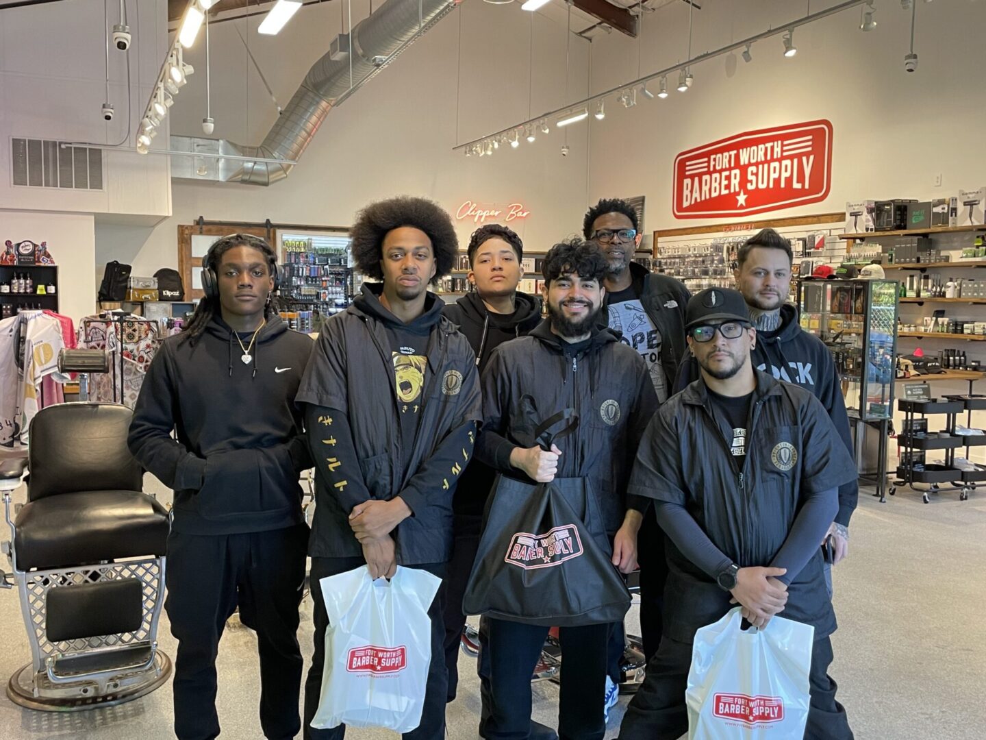 A group of men standing in front of a store.