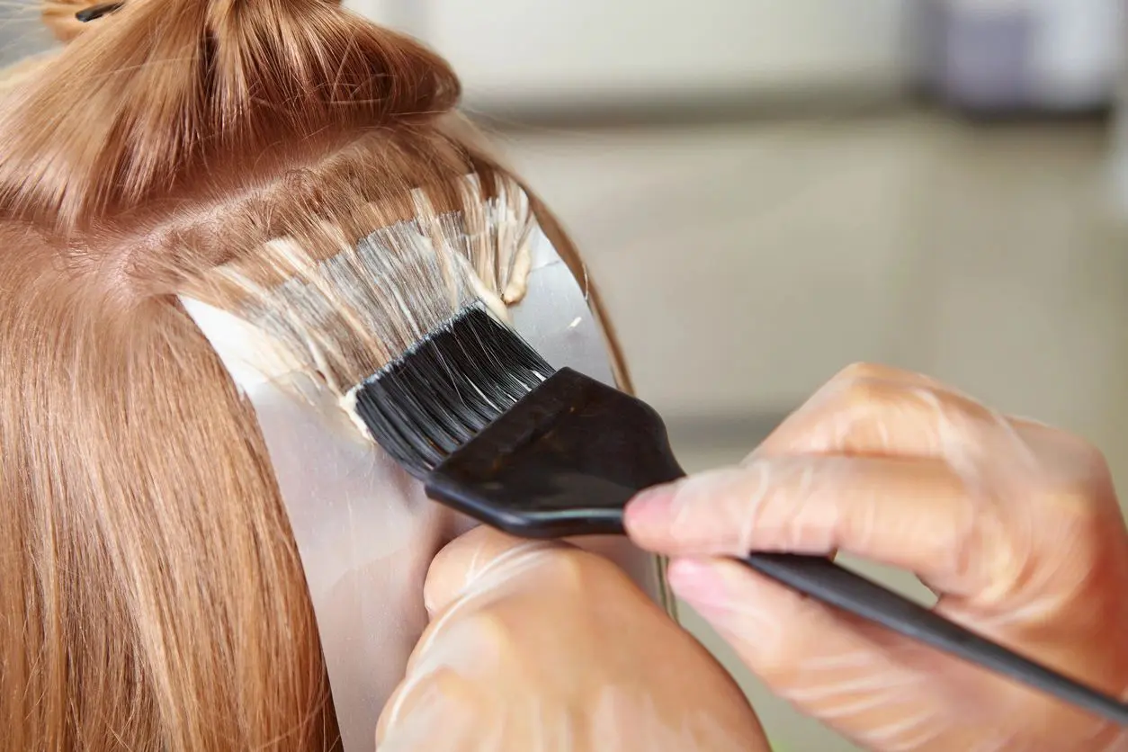 A person is brushing their hair with a brush.