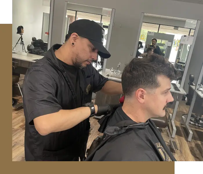 A man getting his hair cut by another man