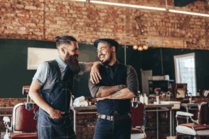 Two smiling male barbers.